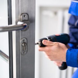bigstock-Locksmith-Man-Repairing-And-Ch-421150730